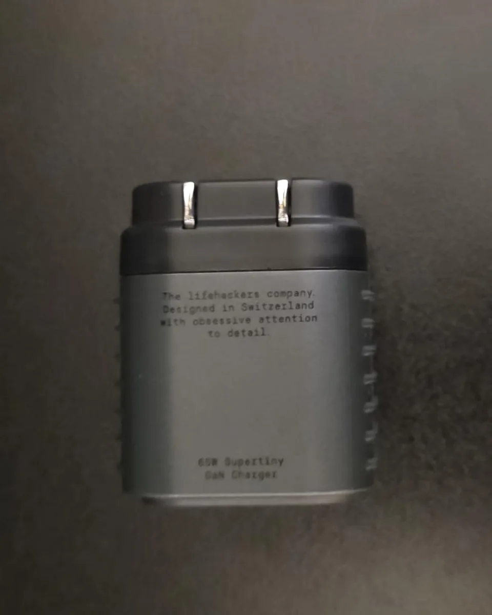 A customer photo of the Supertiny seen from above, its etched lettering readable.